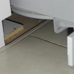 Exposed Concrete Under Cabinet Beside Tile