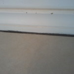 Caulking between the floor time and baseboard trim
